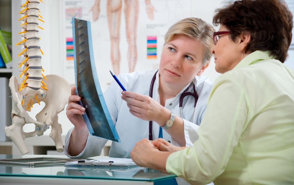 Doctor Showing X-ray To The Patient — Rome, GA — Proctor-Keene Chiropractic Clinic