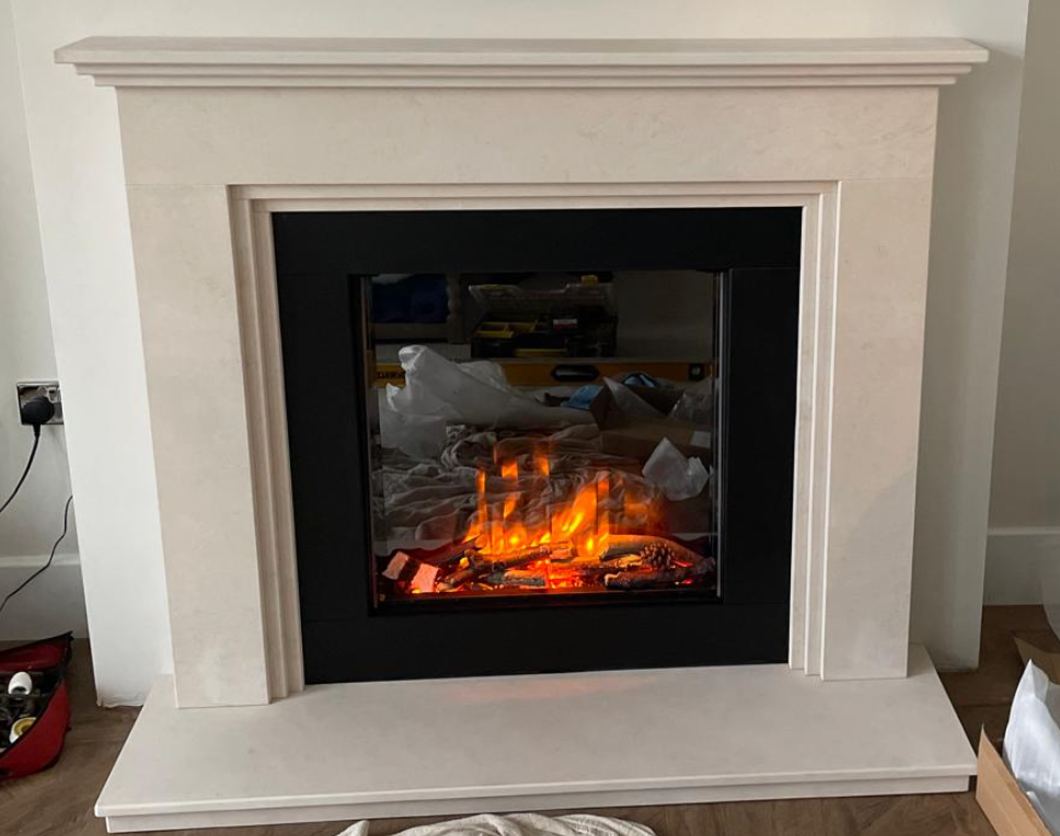 White fireplace mantel with a black electric fire and glowing orange flames in a living room