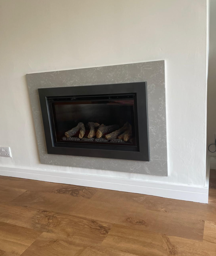 Modern living room with a wall-mounted fireplace framed in gray above hardwood flooring