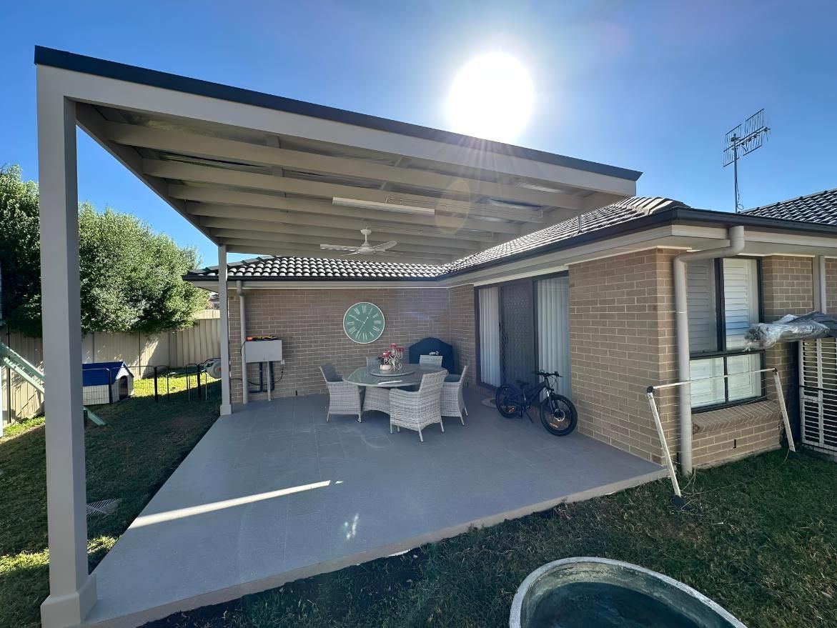 Patio With Gray Roof Extension and Concrete Floor — LD Carpentry in Queanbeyan, NSW