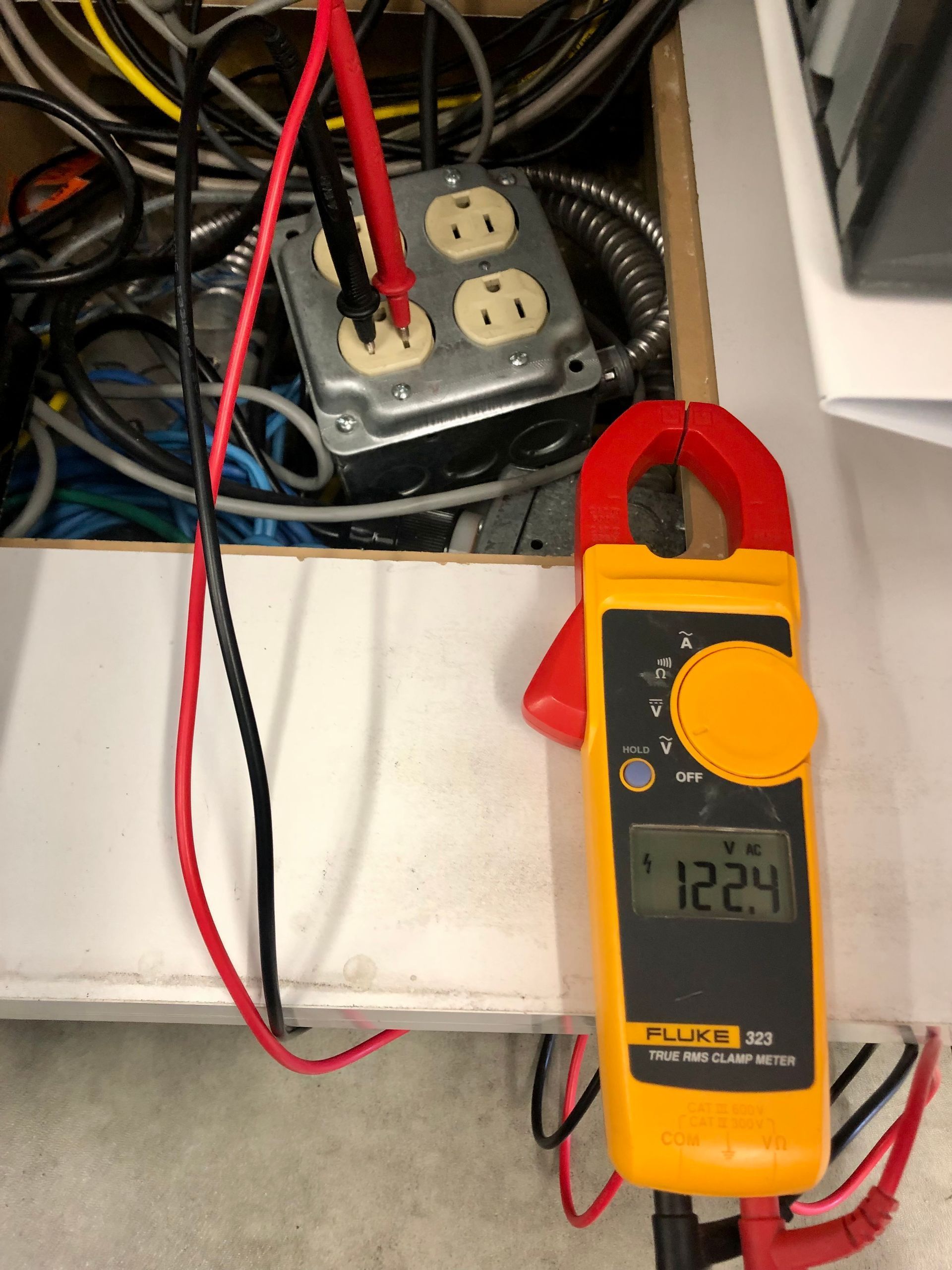 Electrician working safely on switches and sockets of a residential electrical system