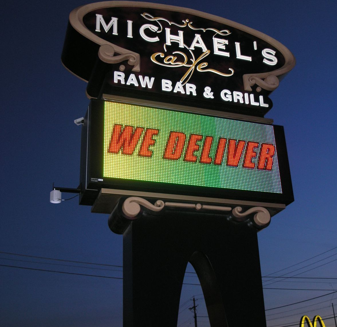Vibrant digital sign displaying dynamic advertising for a Lugoff, SC business by Carolina Signs & Wonders.