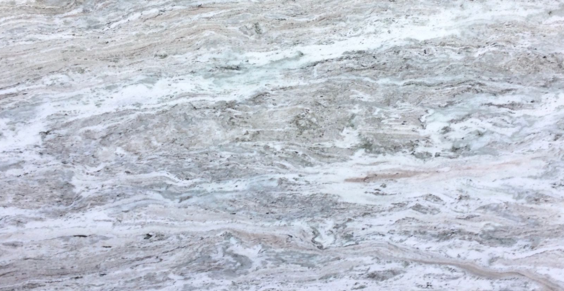 Large beige marble slab displayed in an industrial warehouse setting