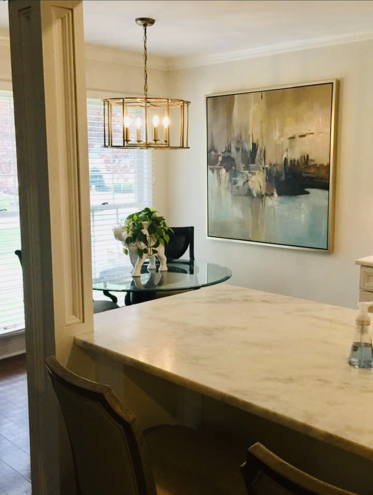 Dining room with marble countertop and a round table. 