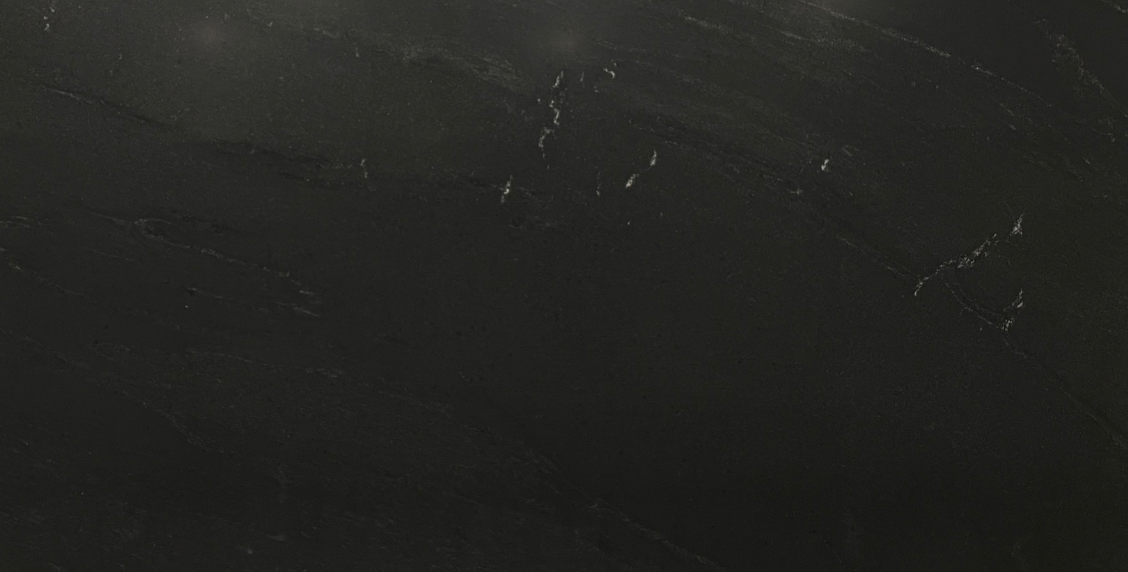 Large black wall-mounted TV in a gray room, with “Nero Mist Home” text above it.