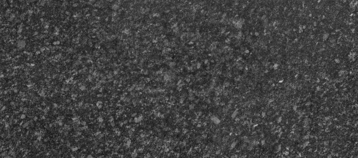 Large gray speckled stone slab on a pallet in a warehouse setting