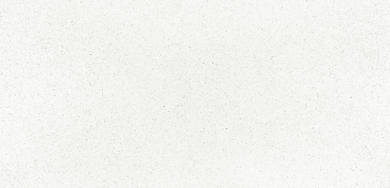 Large white speckled stone slab displayed upright on small supports outdoors.