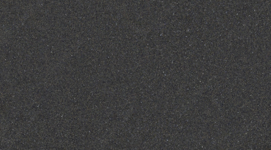 Large dark textured rectangular panel leaning outdoors on a concrete surface, with a small orange clip at the top center