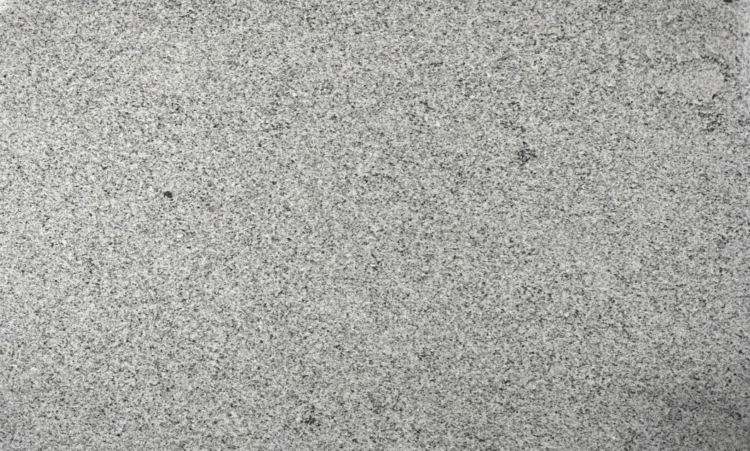 Gray speckled foam board clipped at the top and resting on a dark surface