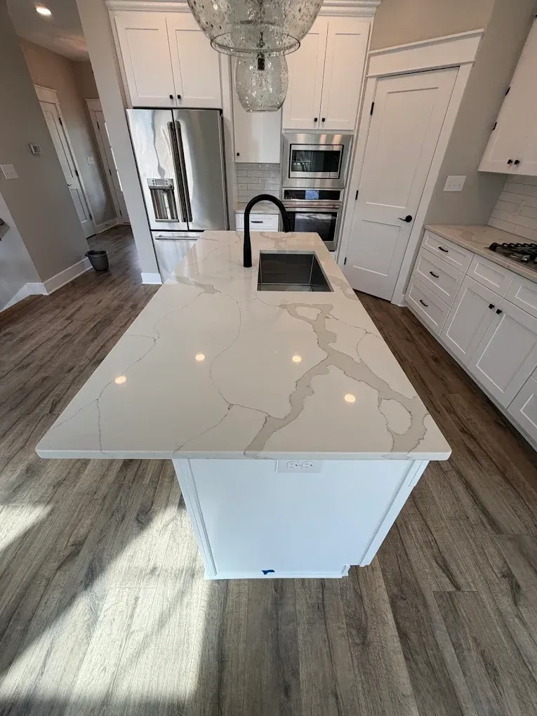 Modern kitchen with white subway tile backsplash, beige cabinets, and a stainless steel gas range.