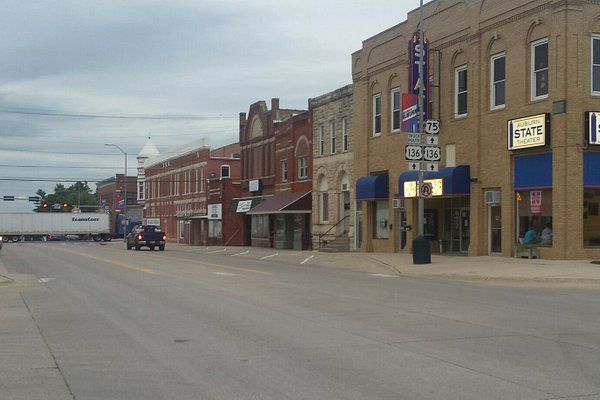 A row of brick buildings with a pepsi sign on the side of one of them