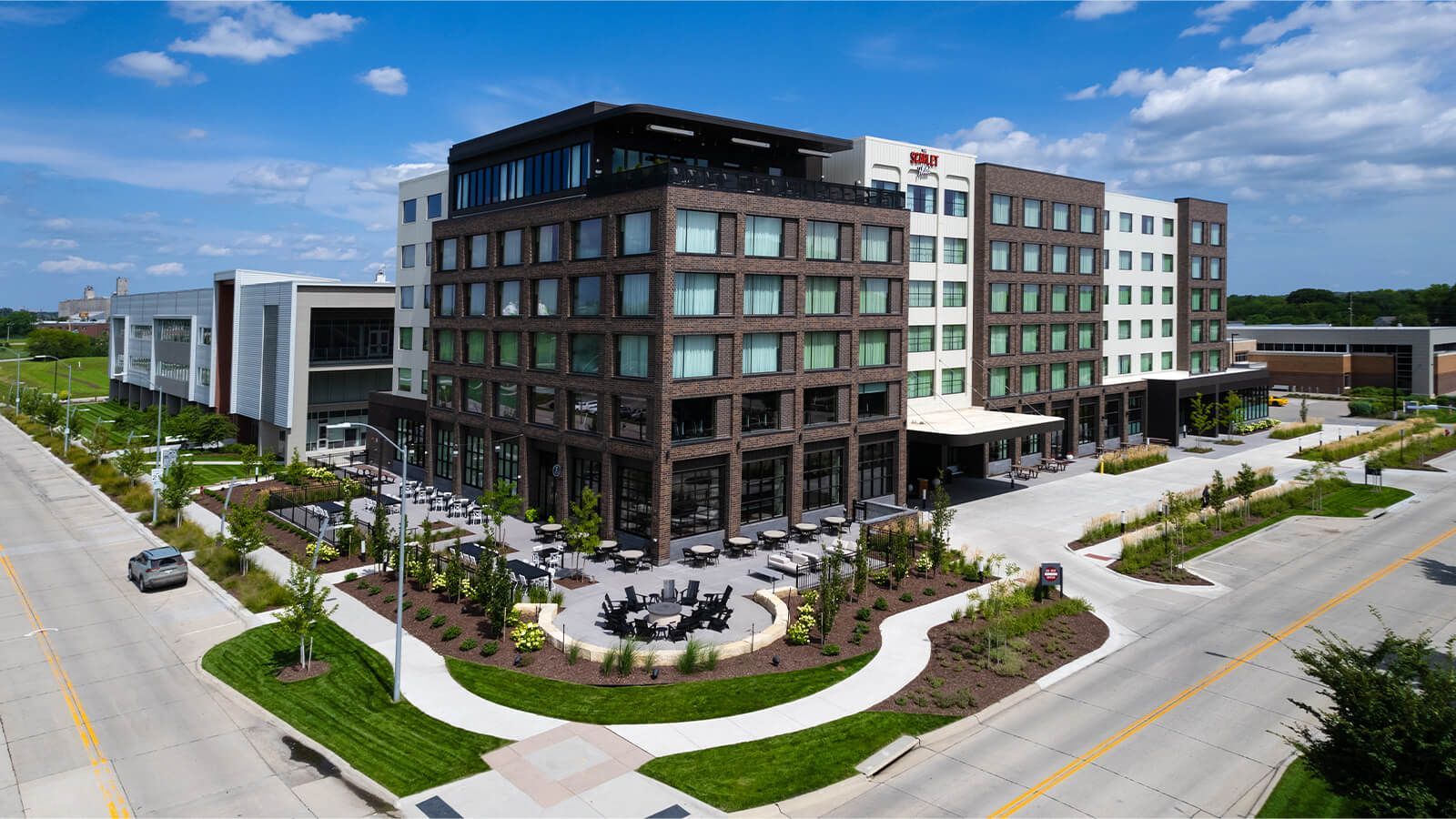 An aerial view of a large building sitting on the corner of a city street.
