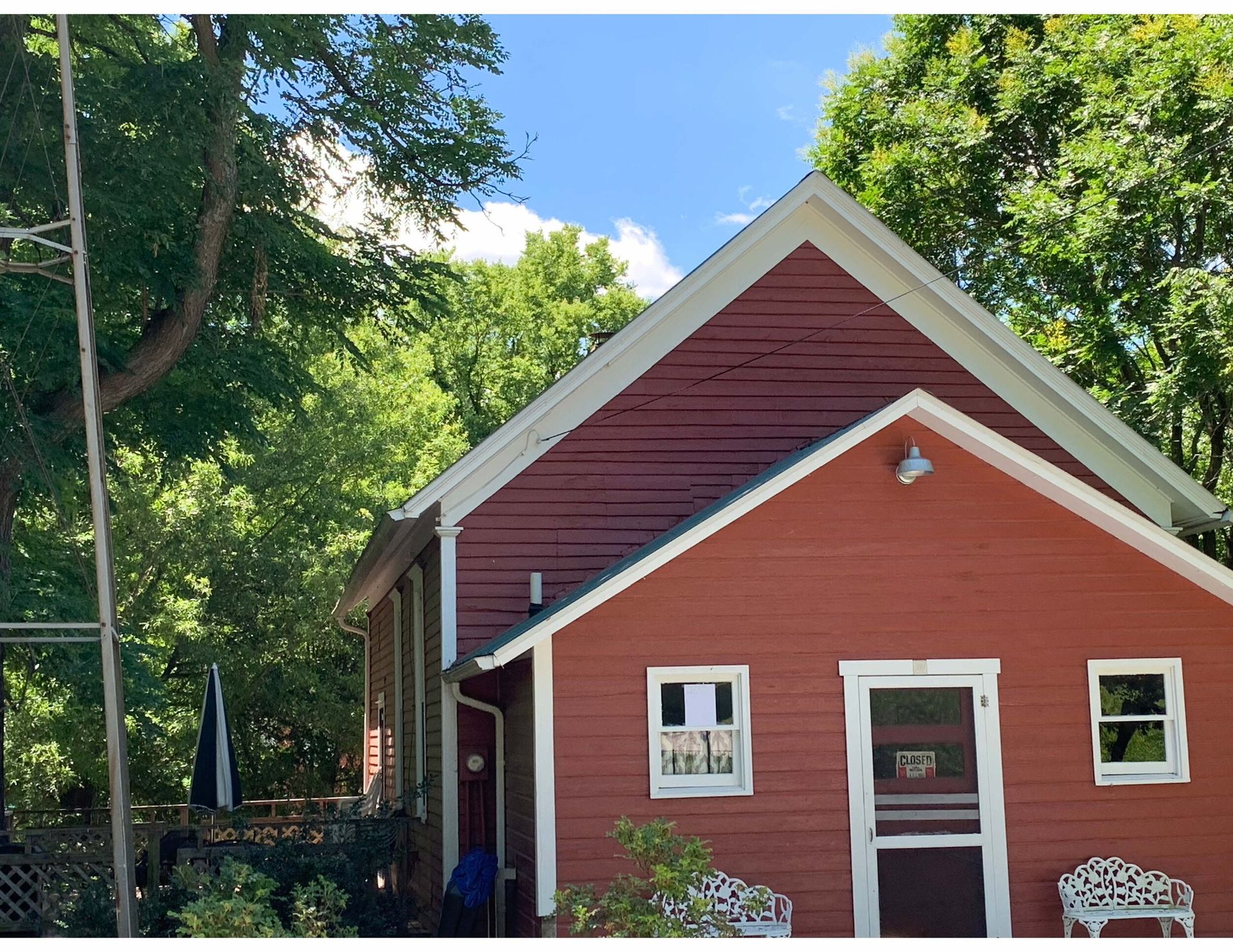 A red house with a white trim and a white door