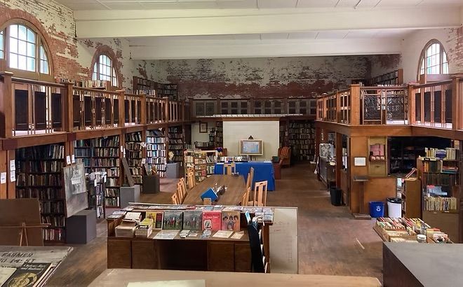 A library with a lot of books and tables