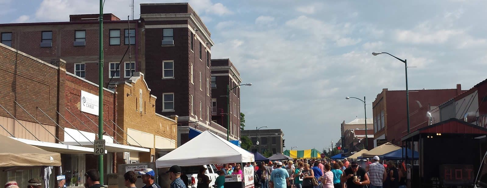 A crowd of people are gathered on a city street.
