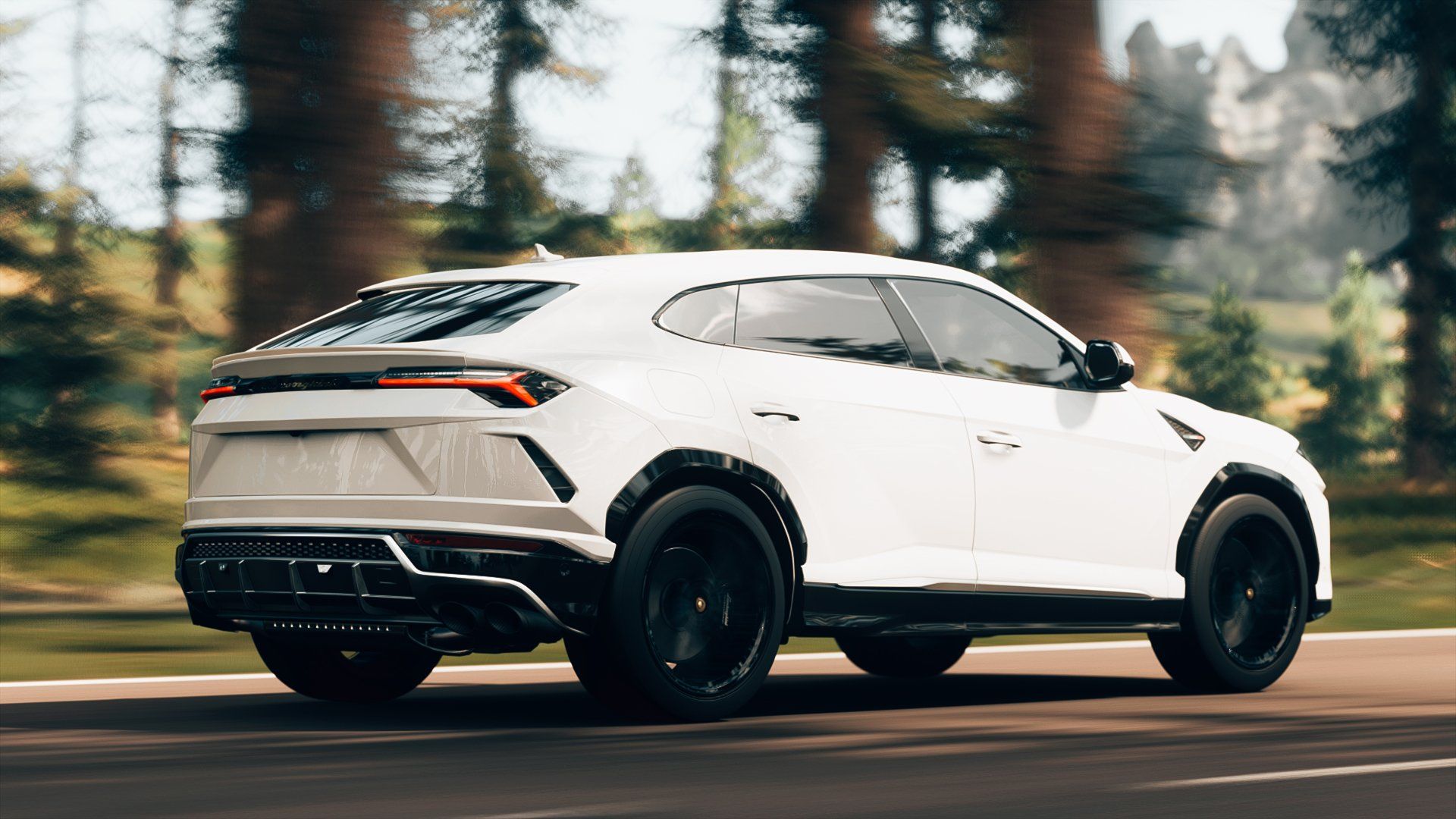 White Lamborghini Urus SUV speeding on a road, black wheels, blurred forest background.