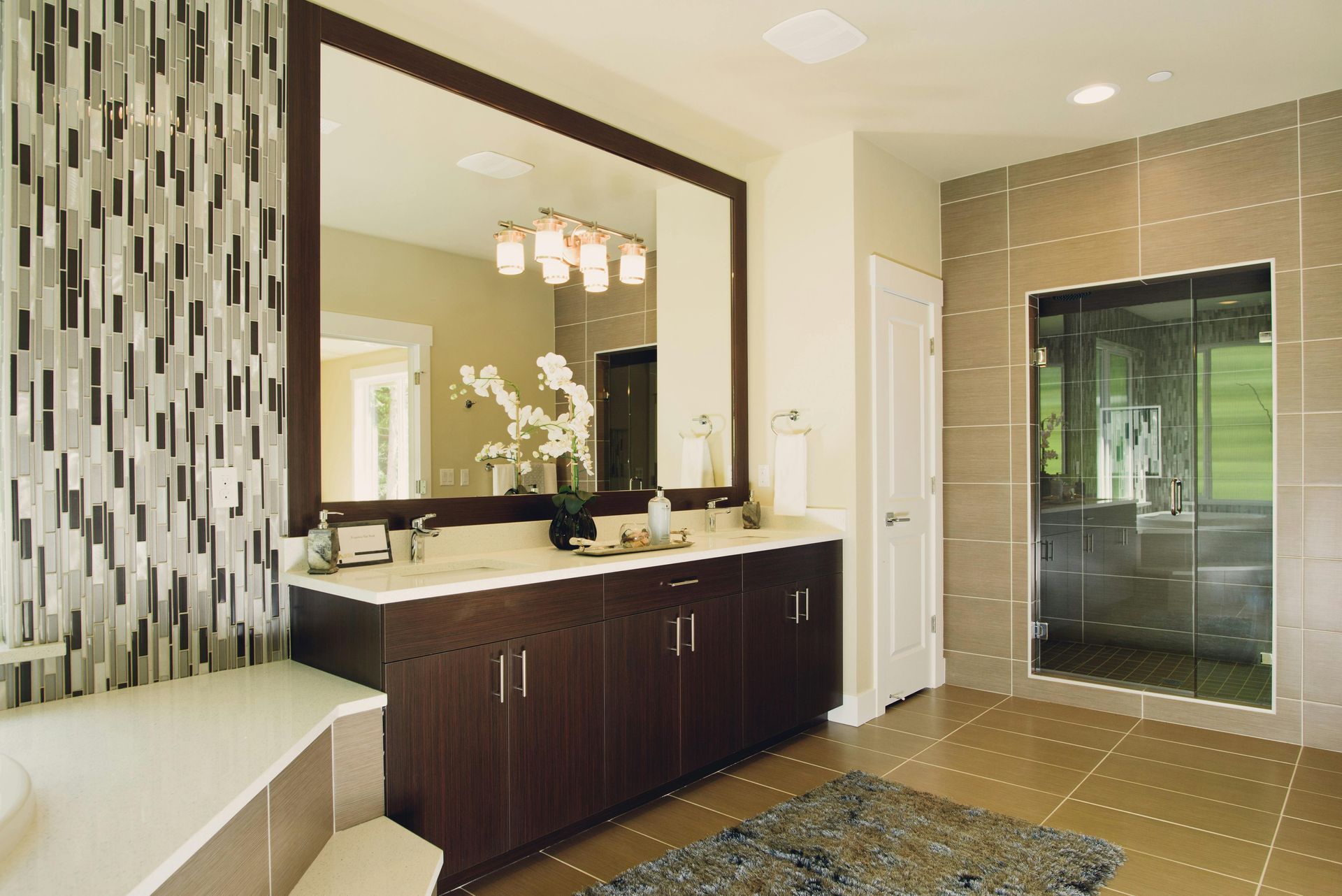A bathroom with two sinks and a large mirror