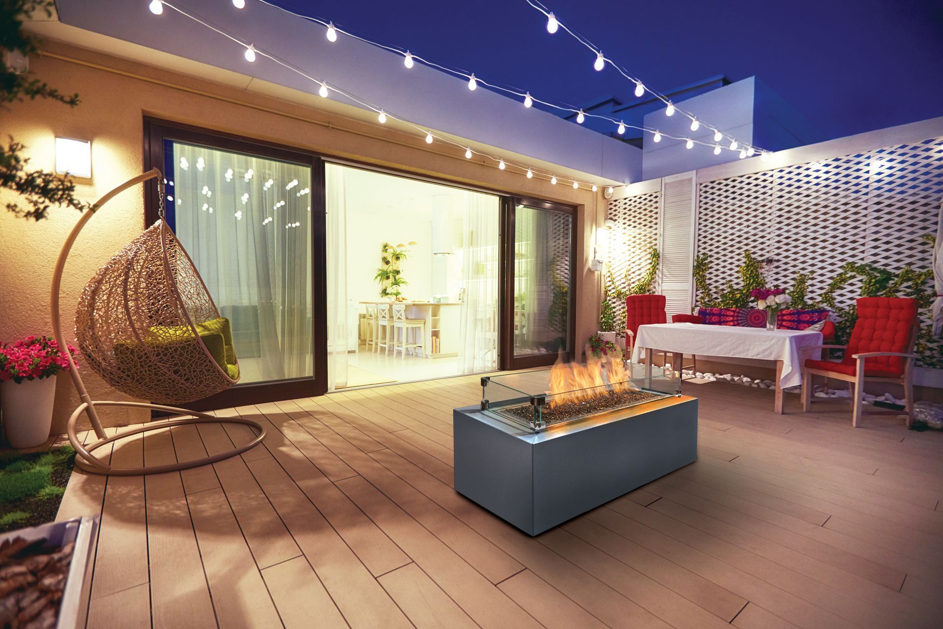 Patio with string lights, wicker chair, lounge table, and dining area outside a modern home