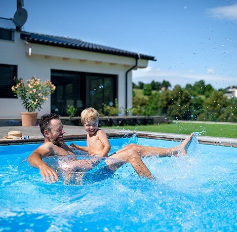 Family playing in pool