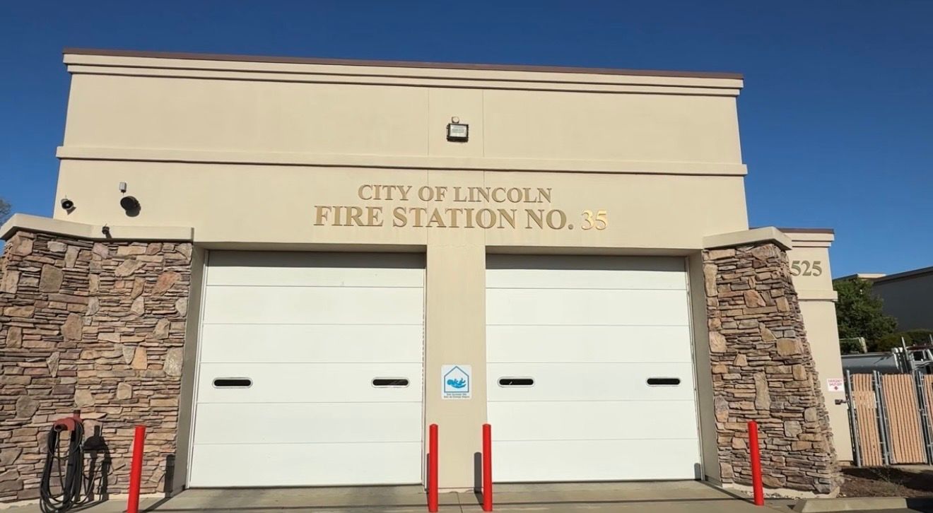 Lincoln Fire Station No. 4 entrance with beige facade, stone sides, and two white garage doors