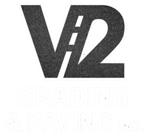 Black V12 logo with faint &ldquo;GRADING & PAVING&rdquo; text beneath
