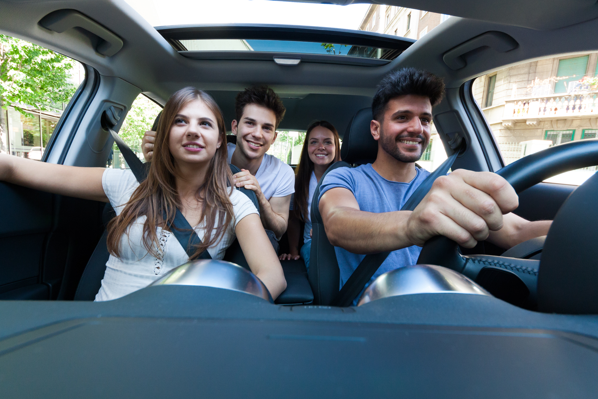 Family driving a modern vehicle on an open Montana road representing reliable auto insurance coverage from Tschetter Agency.