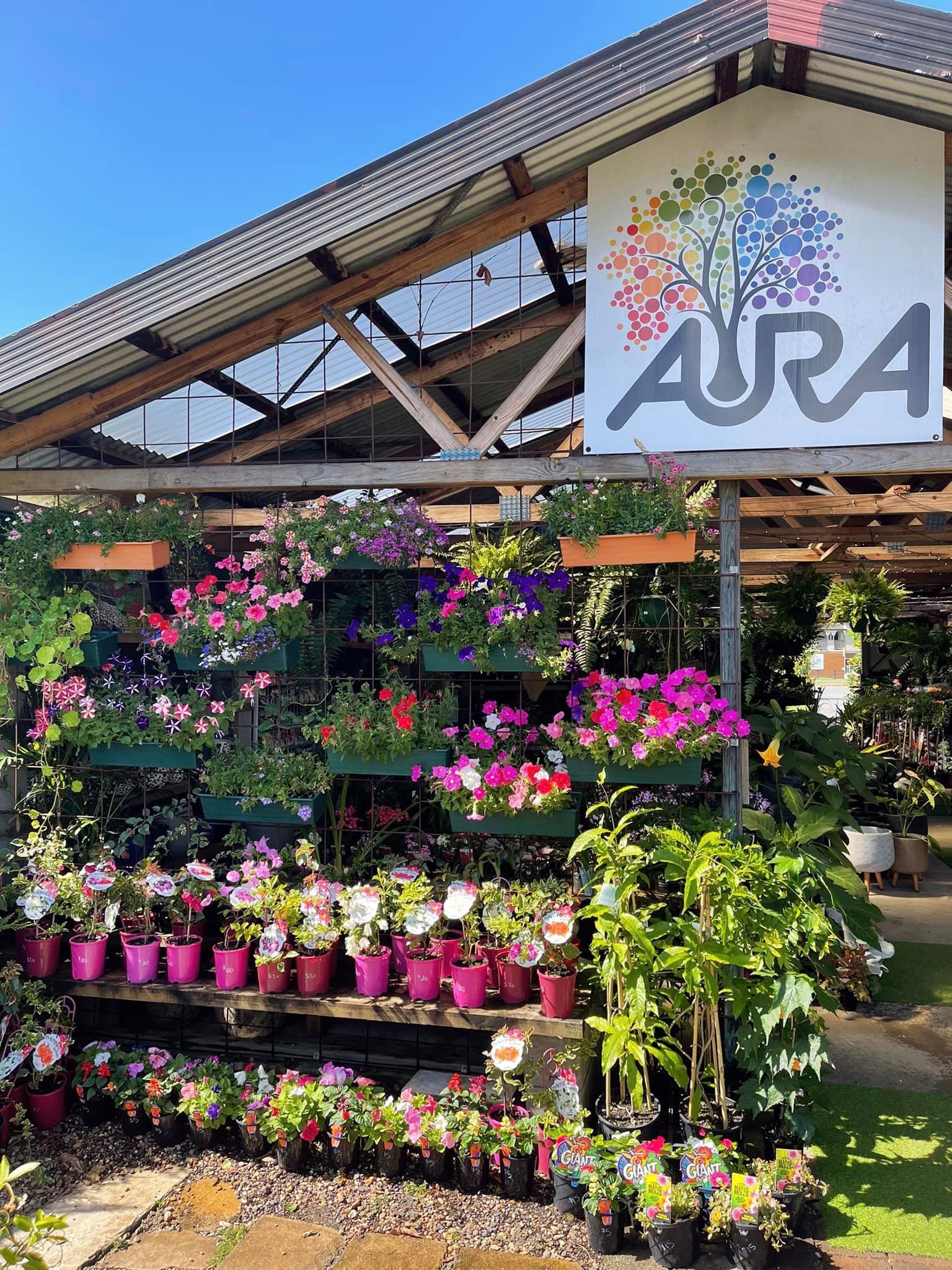 A garden center with a display of colorful flowers and the