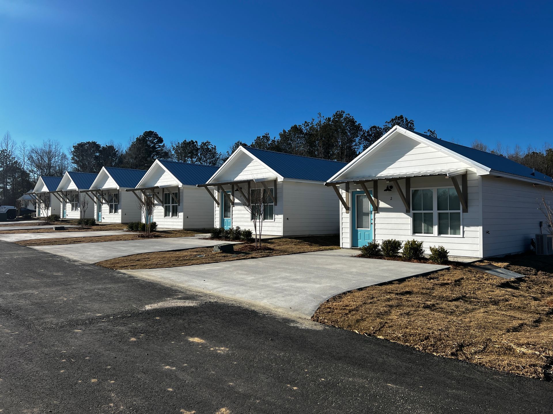 A row of small white houses with blue roofs
