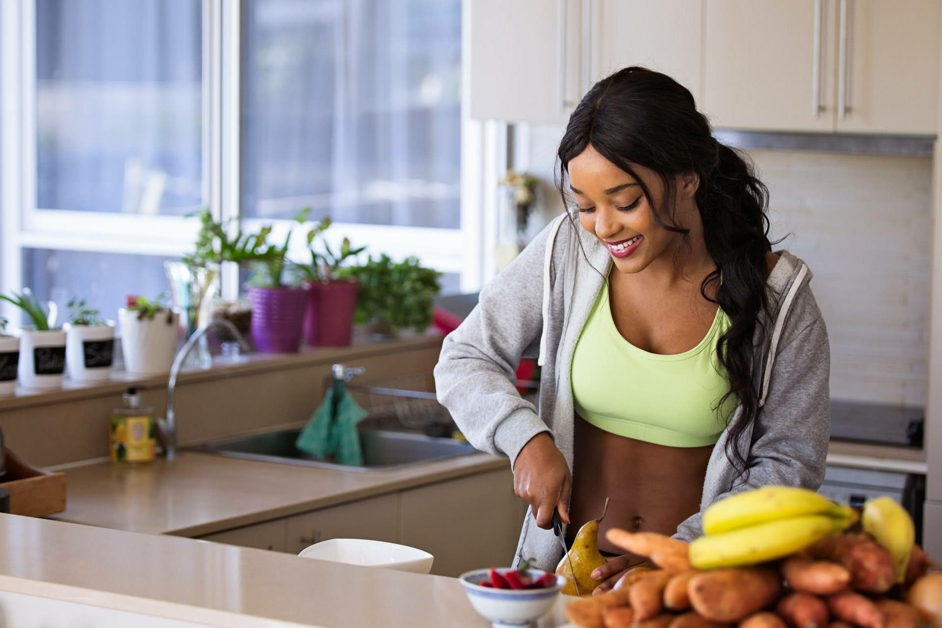 Woman Chopping Fruit — Bloomington & Champaign, IL — Luther Falls Custom Kitchens