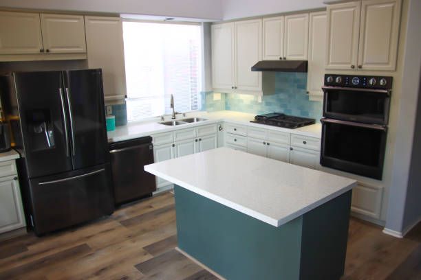 A kitchen with a large island in the middle of it - Luther Falls Kitchen & Bath - Champaign, IL