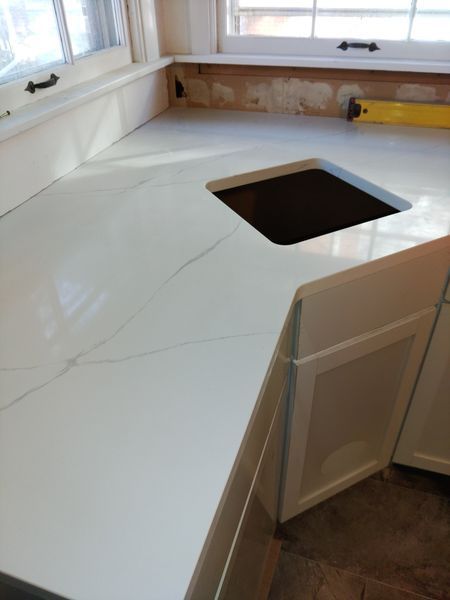A kitchen counter with a sink and a window - Luther Falls Kitchen & Bath - Champaign, IL