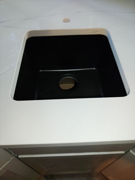 A black sink is sitting on top of a white counter - Luther Falls Kitchen & Bath - Champaign, IL