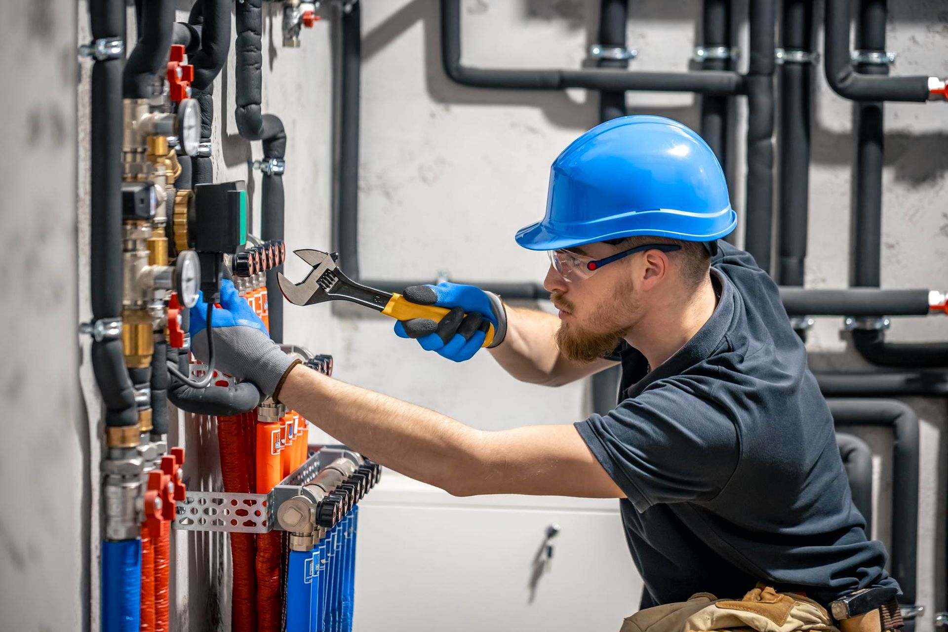 Professional handyman fixing plumbing and electrical systems in a home