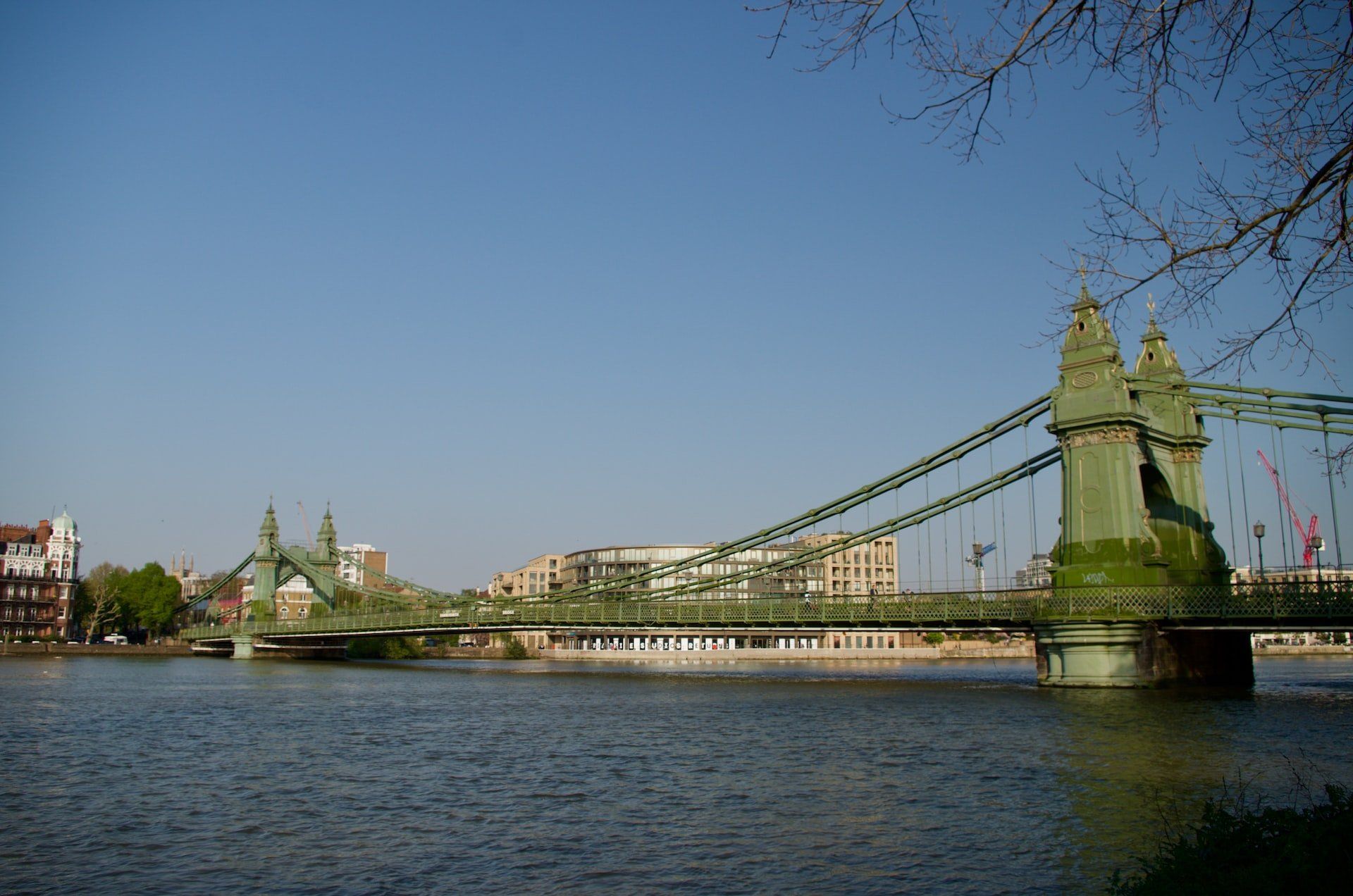 River view of London’s Tower Bridge under a clear blue sky