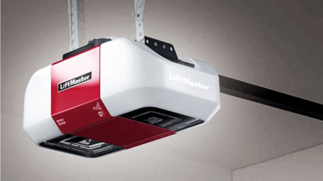 A red and white garage door opener is hanging from the ceiling.
