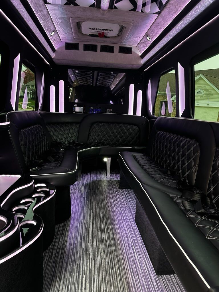 Luxurious black leather limousine interior with purple lighting and quilted seats