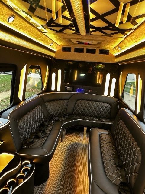 Luxury limo interior with quilted black leather seating and gold ceiling lighting