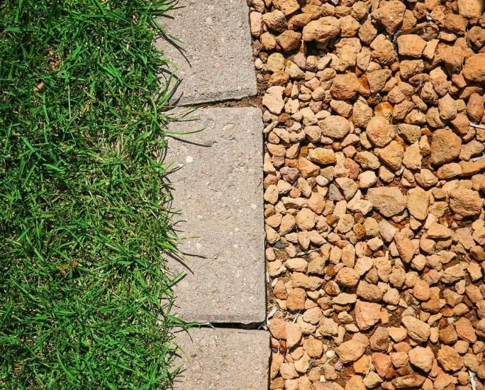There is a Brick Border Between the Grass and the Gravel — The Brick Paving Centre in Winnellie, NT