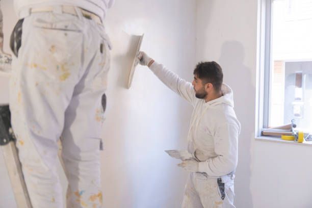 Two men are plastering a wall in a room. — New Windsor, NY — JJ Interior Restorations Corp.