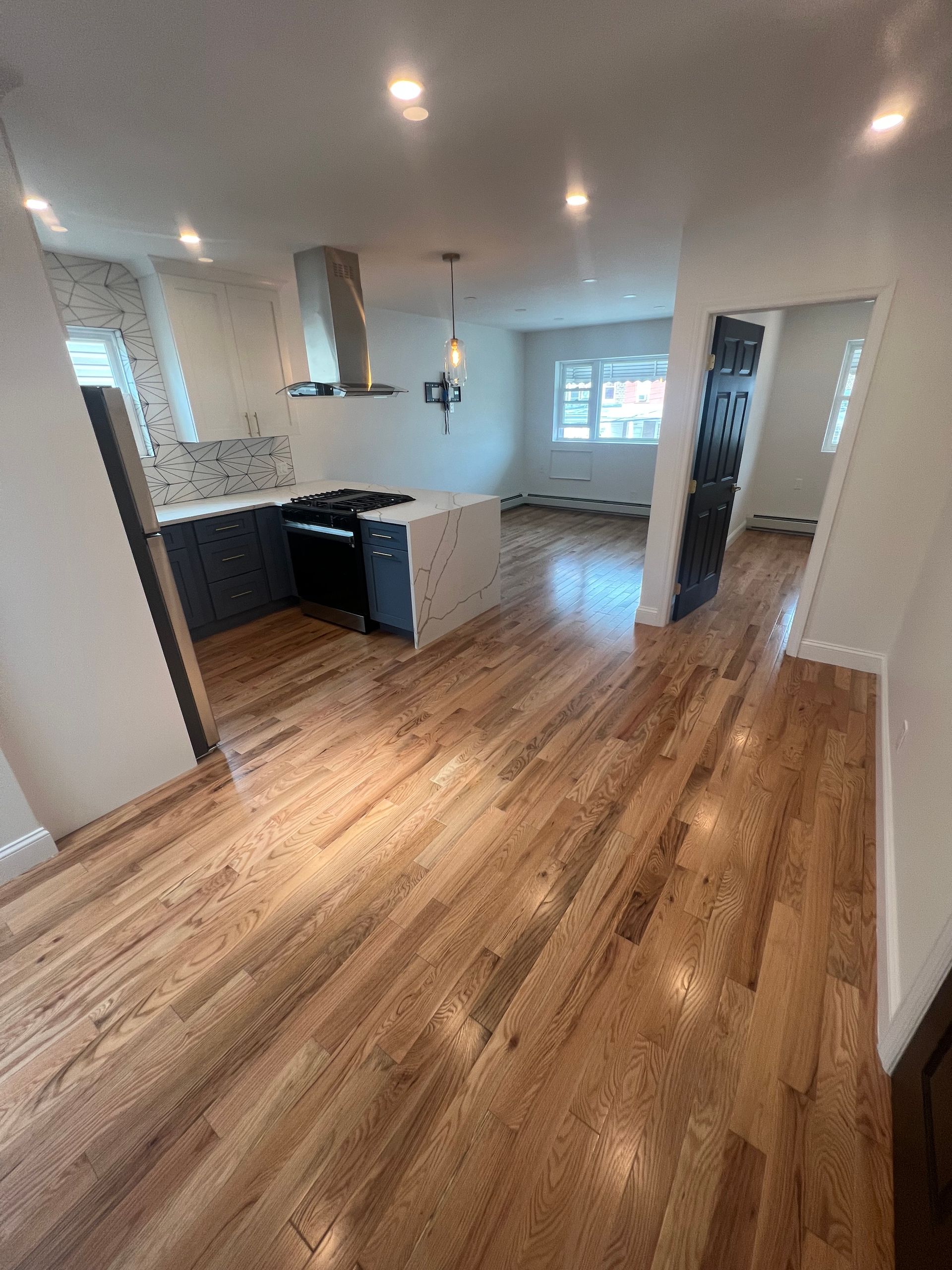A person is kneeling on the floor holding a hammer. — New Windsor, NY — JJ Interior Restorations Corp. A person is kneeling on the floor holding a hammer. — New Windsor, NY — JJ Interior Restorations Corp.