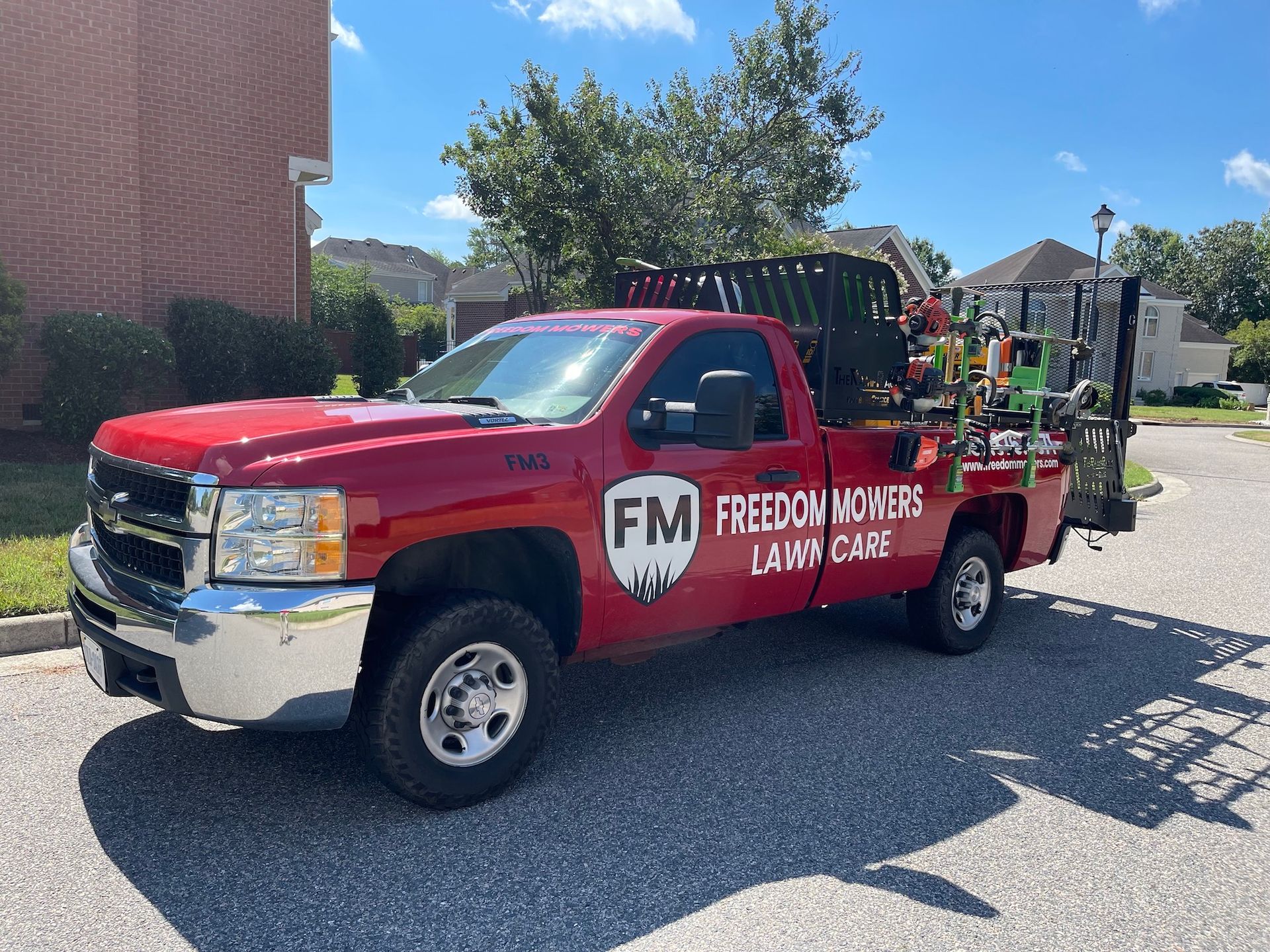 A red truck is parked on the side of the road.