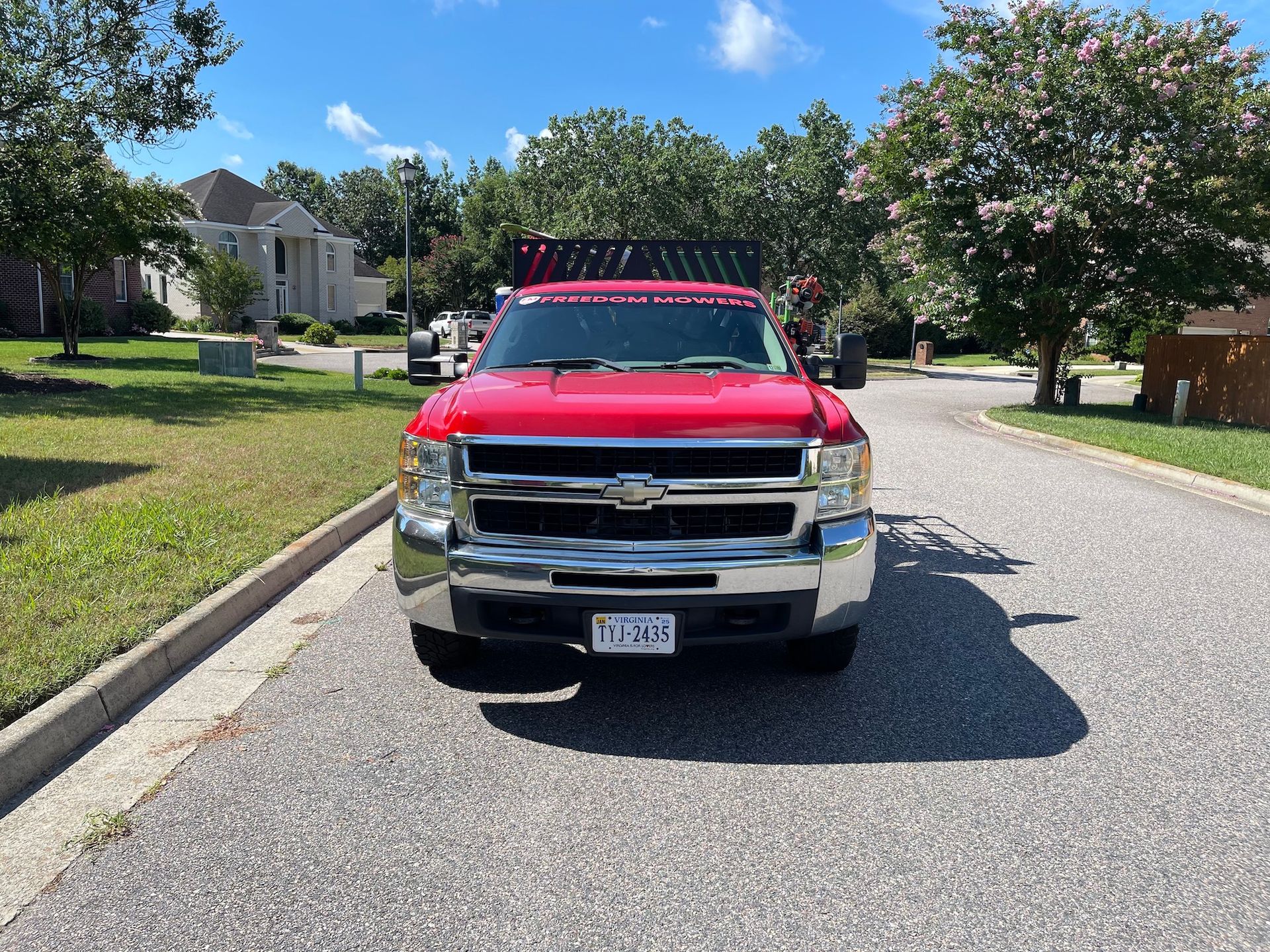 A red truck is parked on the side of the road.