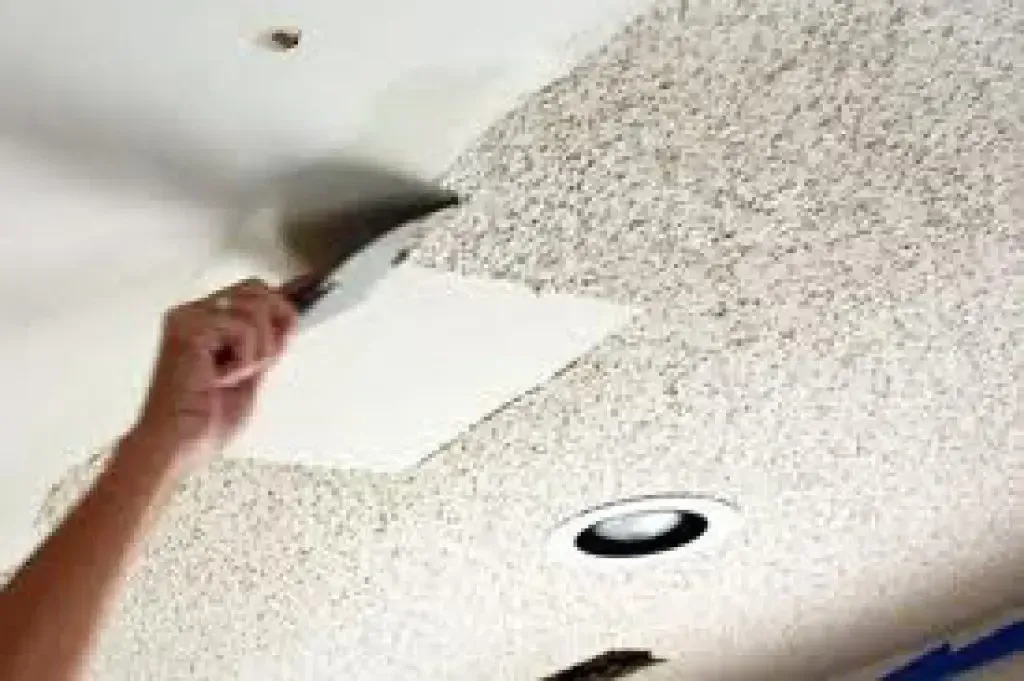 A popcorn ceiling containing asbestos being removed