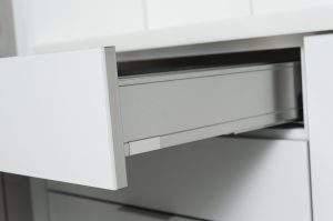 White drawer partially open under a countertop