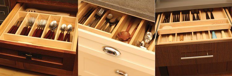 Three wooden drawers with neatly organized kitchen cutlery and utensils inside.