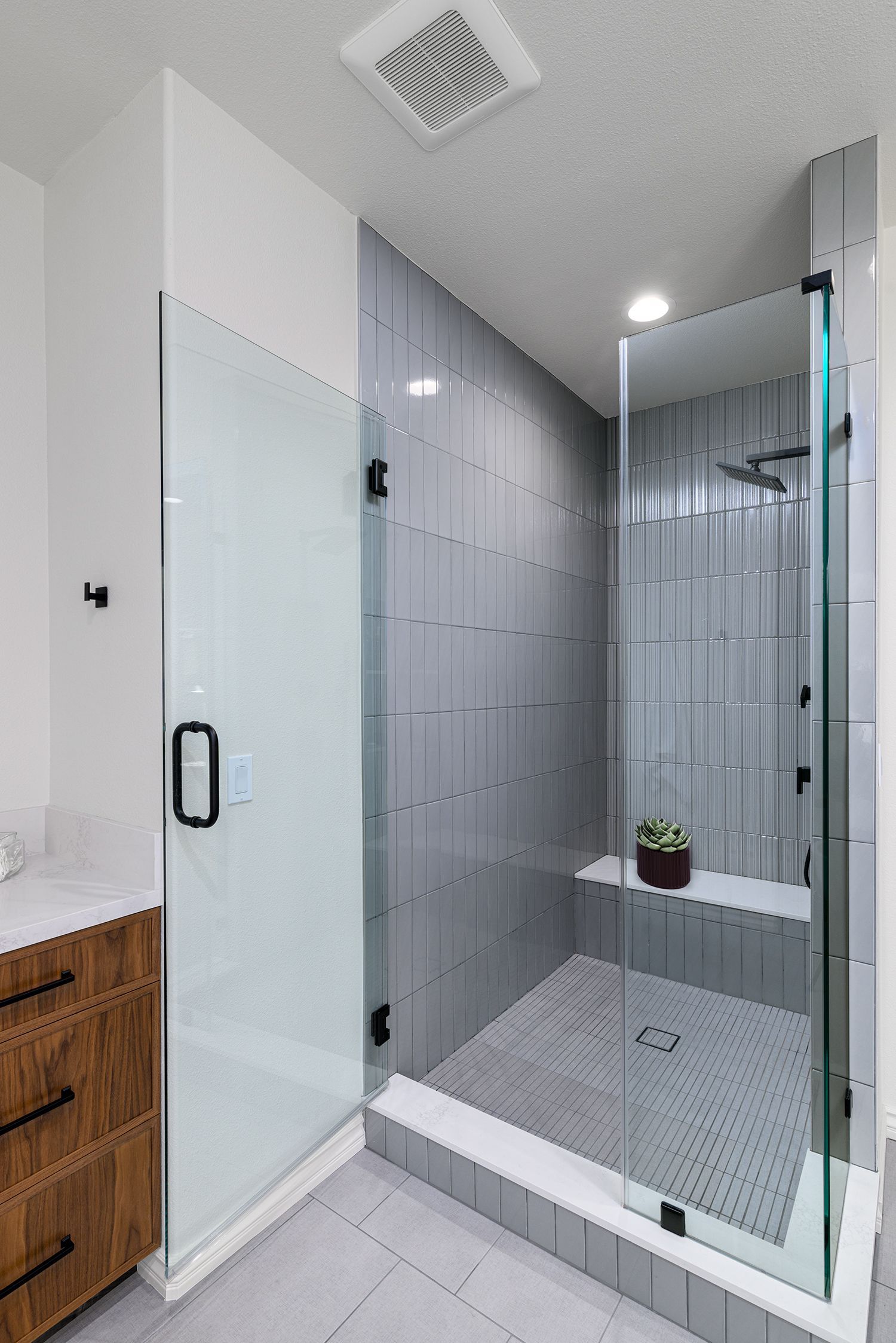 image shows a shower with a seating bench and soft gray tile, Primary Bathroom Remodel, Thousand Oaks, CA 