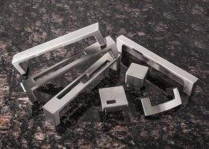 Metal letterblocks scattered on a dark speckled surface