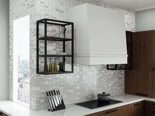 Modern minimalist kitchen with white cabinets, black shelving, and a stovetop by a mosaic-tiled wall