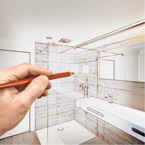 Hand sketch of a modern bathroom renovation plan with a pencil over a tiled shower and sink layout