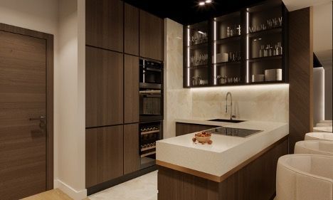 Modern kitchen with wood cabinetry, island sink, glass-front cabinets, and staircase beside a doorway